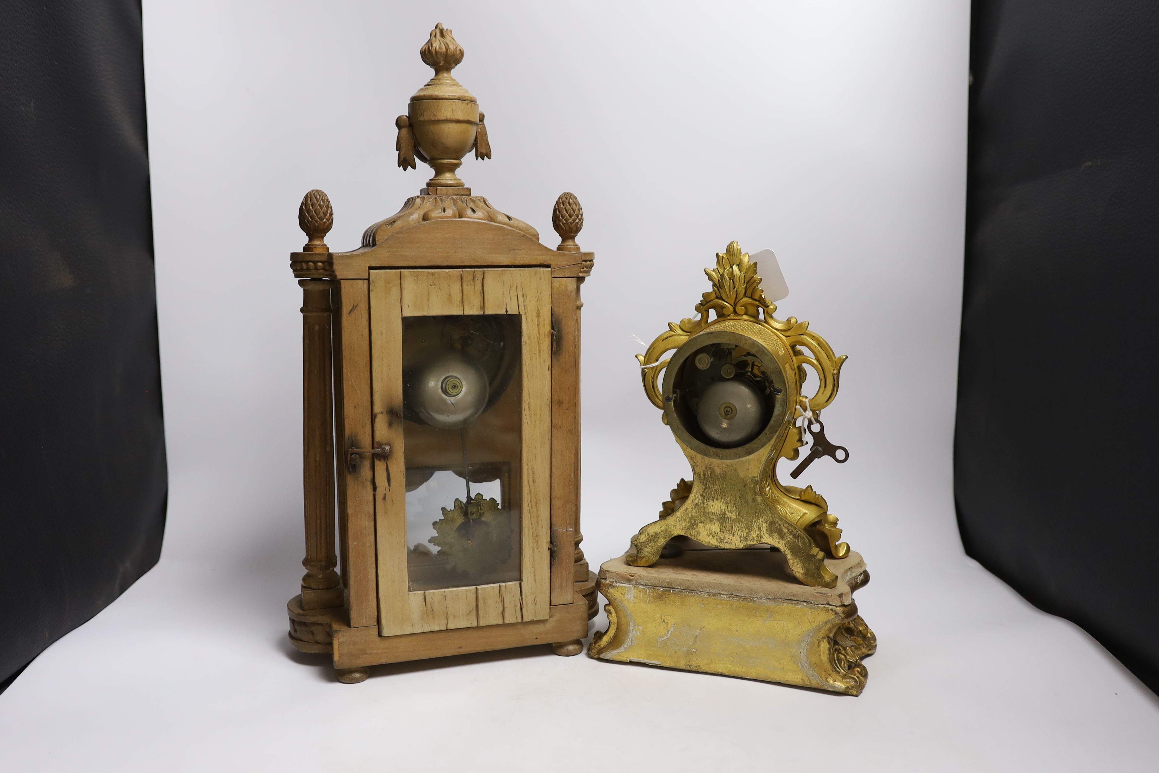 A late 19th century French carved blonde wood mantel clock and similar gilt metal mantel clock. Tallest 45cm